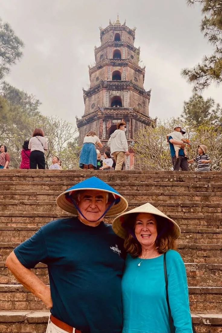 Places to visit in Vietnam: Robin and cos with Vietnamese hats in front of the Thiên Mụ Pagoda