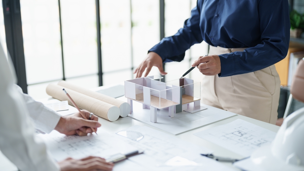 Architectural plans and building regulation documents spread out on a table