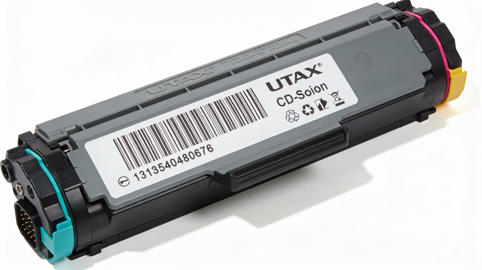 Close-up of a UTAX CD toner cartridge, showing compatibility labels and model numbers